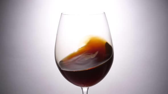 Wine Is Stirred Inside A Glass