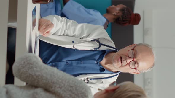 Vertical Video Retired Woman Signing Appointment Papers for Prescription Pills