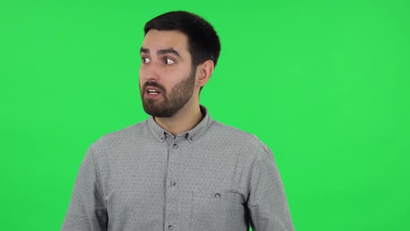 Portrait of Brunette Guy Is Very Angry and Screaming. Green Screen