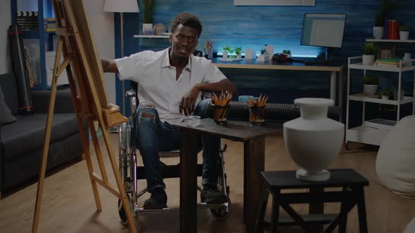 African American Man Sitting in Wheelchair While Drawing