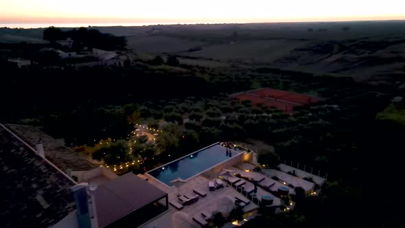 Couple on Vacation at Luxury Resort in Sicily During Sunset By the Infinity Pool in Sicilia Italy