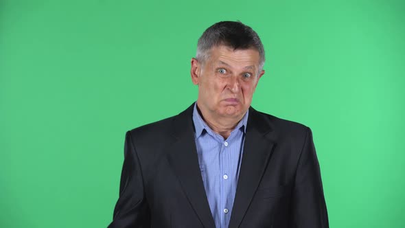 Portrait of Aged Man Looking at Camera with Anticipation, Then Very Upset Isolated Over Green