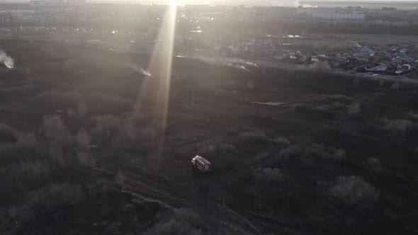 Firemen Near Burning Grass