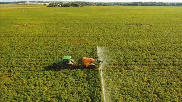 Tractor Is Spraying Fertilizers Field