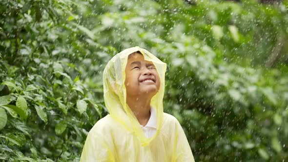 Happy boy wears raincoat