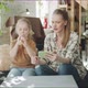 Mom Teaches Daughter to Play the Flute By Showing a Video on the Phone - VideoHive Item for Sale