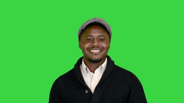 Casual African American Man in a Hat Smiling on a Green Screen Chroma Key