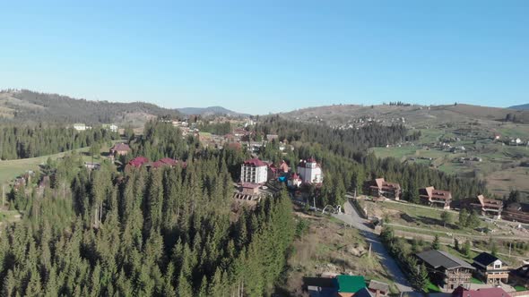 Pine woods forest and mountain valley. Beautiful Carpathian mountains against blue sky.