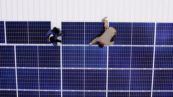 Solar Technician Installing Solar Panels on House Roof