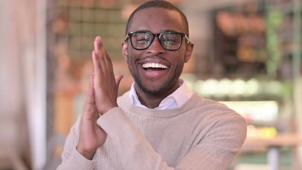 Portrait of Excited African Man Clapping Cheering