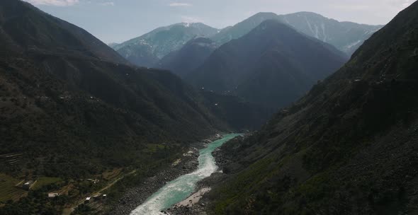 Aerial View Over River Running Through Swat Valley Floor. Slow Dolly Forward