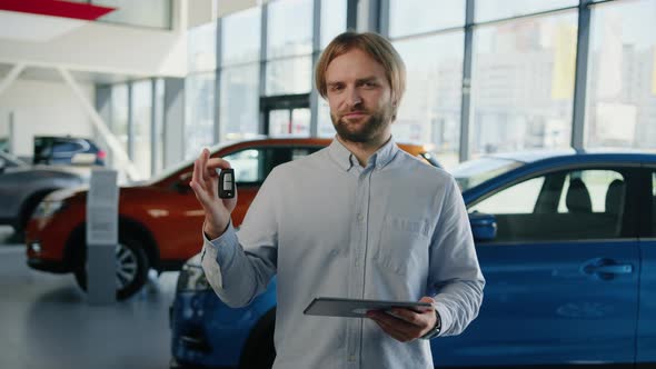 Successful Car Dealership Manager with a Tablet in His Hands