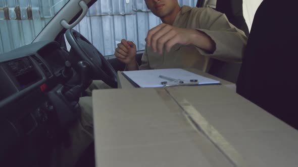 Young male van driver with a warehouse delivery