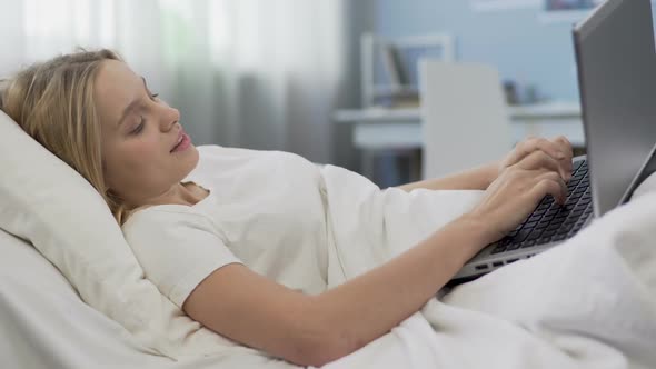 Teenage Girl Lying in Bed With Laptop, Social Networking Addiction Problem