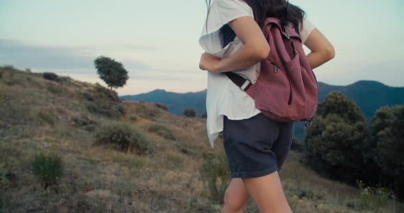 Traveler Female Climbing Up to Mountain with Backpack on Summertime Adventure