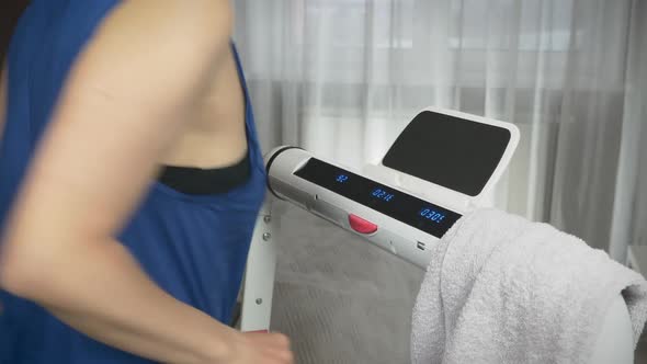 Overweight woman is running on treadmill