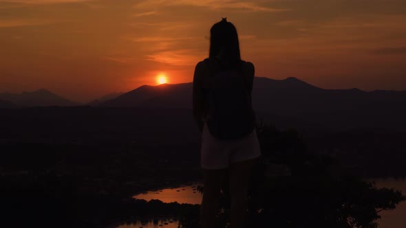 Silhouette of the Girl From Behind Watching the Sunset in the Mountains