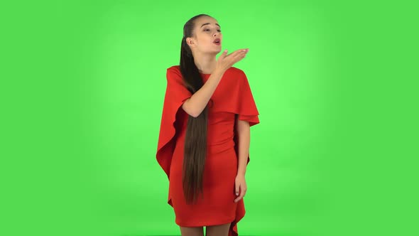 Pretty Young Woman Is Blowing Kisses. Green Screen