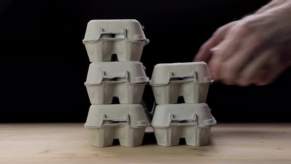 Man Stacking Egg Paper Packaging