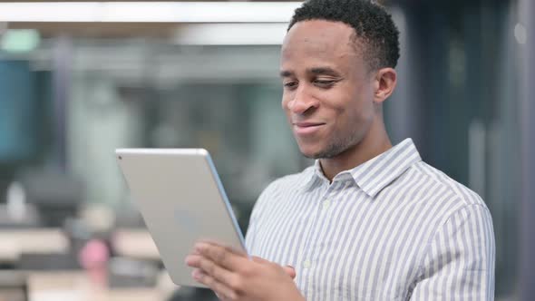 African Businessman Using Tablet Browsing Internet