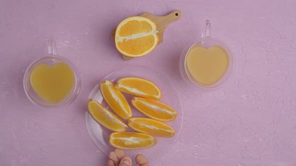 Glass of Orange Juice with Oranges Top View Amaranth Pink Background