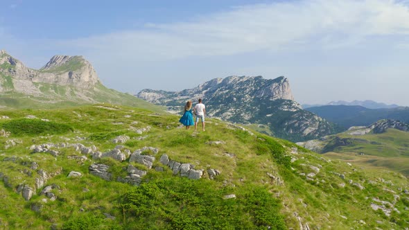 Sporty Young Couple Trekking High in the Scenic Mountains During Their Active Spring Holiday in