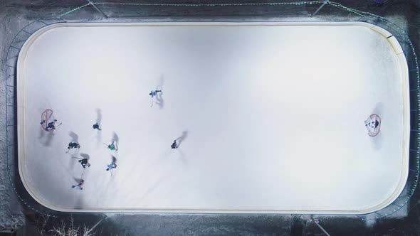 Playing Ice Hockey on Ice Rink. Aerial Vertical Top-Down View