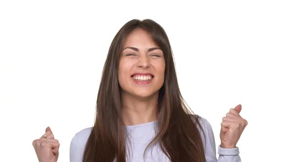 Happy Caucasian Young Brunette Lady in Lavanderblue Sweater Actively Rejoicing Over White Background