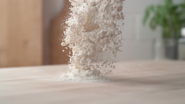 Pouring flour onto a cooking table. Shot with high speed camera, phantom flex 4K. Slow Motion.