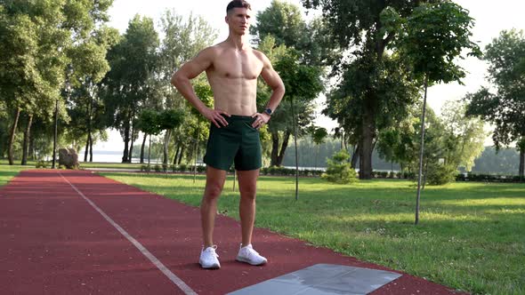 Athletic Man with Muscular Body Ready for Training Outdoor in Park Motivation