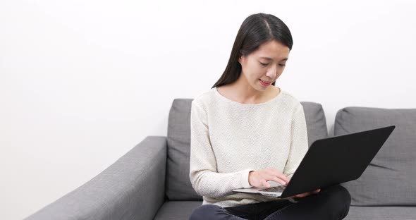 Woman working on laptop computer at home