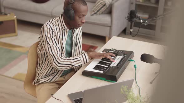 African Man Making Music in Home Studio