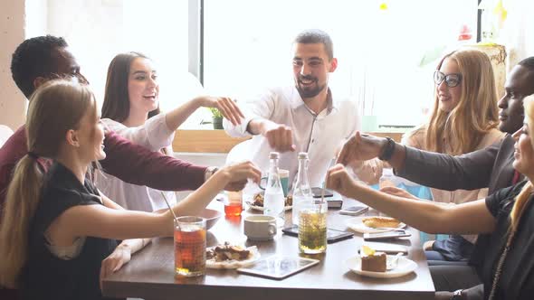 Multi-ethnic Friends Laughing Having Fun at Meeting in Coffeehouse.