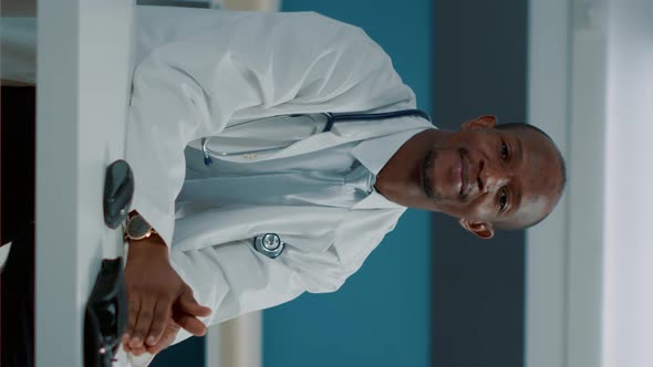 Vertical Video Portrait of African American Doctor with White Coat and Stethoscope