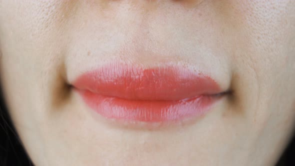 Woman Applying Lipstick and Smiling Closeup