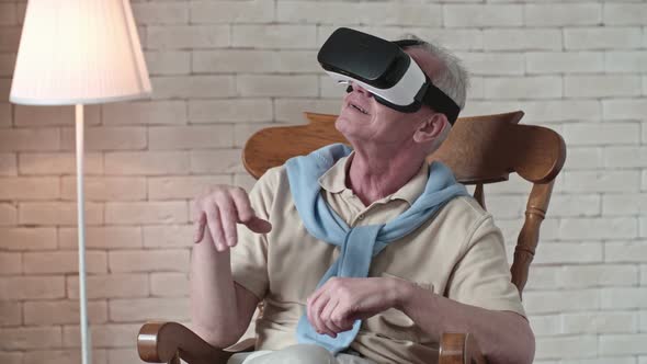 Elderly Man in Rocking Chair Wearing VR Headset