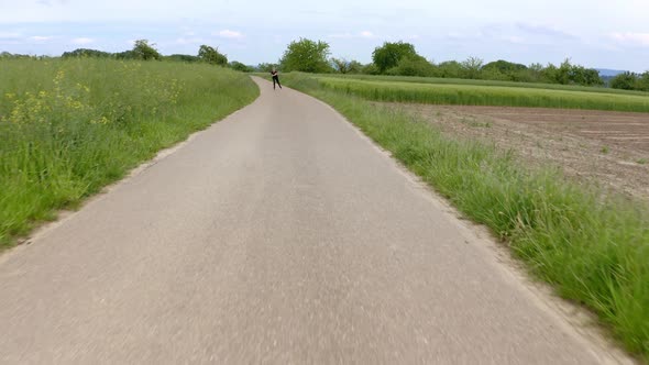 Real time shot of young woman inline skating