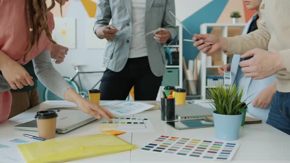 Designers of Smartphone Applications Put Color Swatches on Table During Meeting