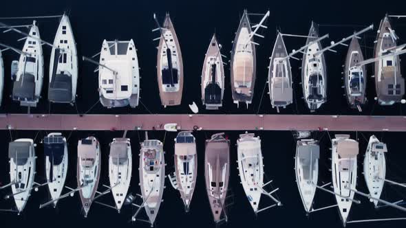 Aerial Footage of the Piers with Luxury Yachts in Blue Sea Filmed From Above