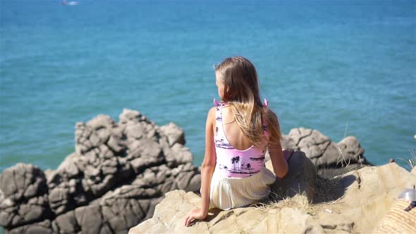 Happy Kid Outdoor on Edge of Cliff Seashore