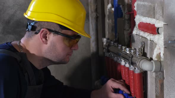 Close Up of Plumber Eliminates Water Leak in Pipeline