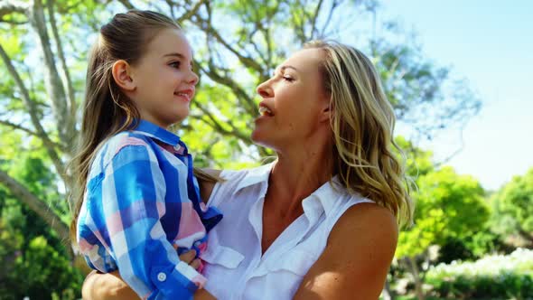 Mother and daughter embracing each other in park 4k