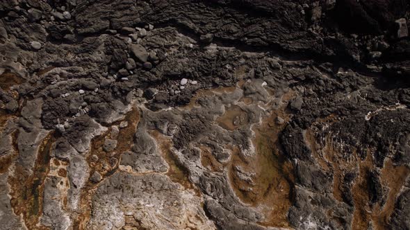 Dark Lava Rocks Texture Revealing Ocean Coast in Azores