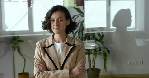 Portrait of Happy Satisfied Young Arabic Caucasian Business Woman Student Freelancer Sitting in