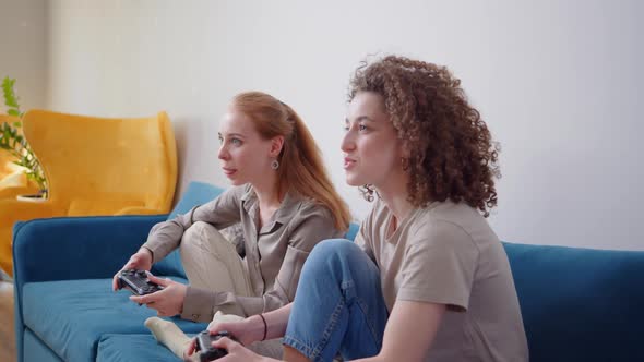 Lesbian LGBTQ Women Couple Play Video Game at Home