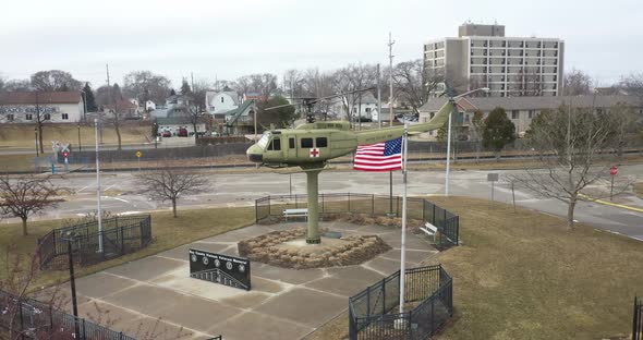 Vietnam veterans memorial with helicopter in Bay City, Michigan. Drone videoing over helicopter.