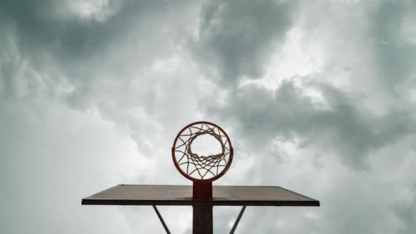  View from below of basketball hoop during the arrival of a heavy storm, Timelapse