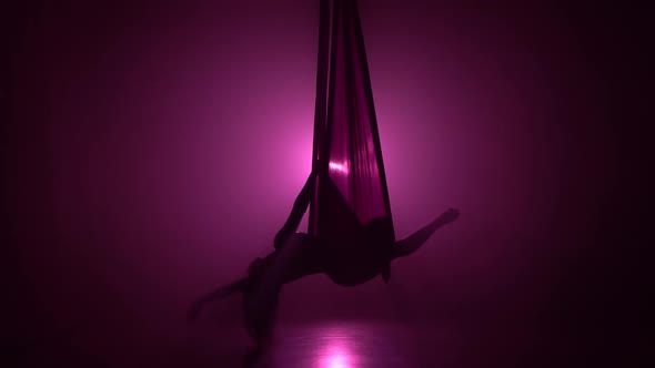 Silhouette Girl Dancing with Aerial Silk Flying Wings in Violet Background 071