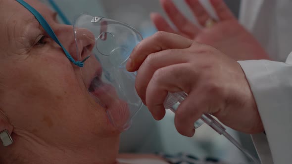 Close Up of Doctor Applying Oxygen Mask on Ill Patient