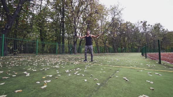 Sportsman doing exercise. Fit athlete doing exercises at stadium